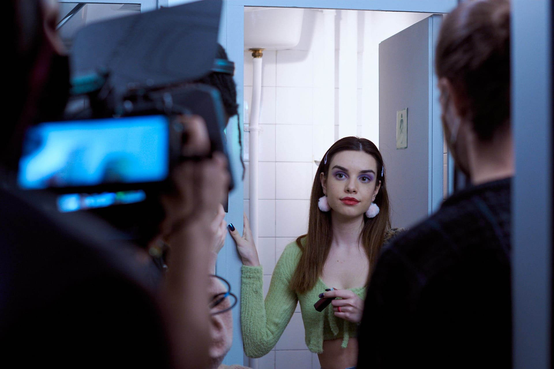 An actress seen from behind the monitor during a shoot